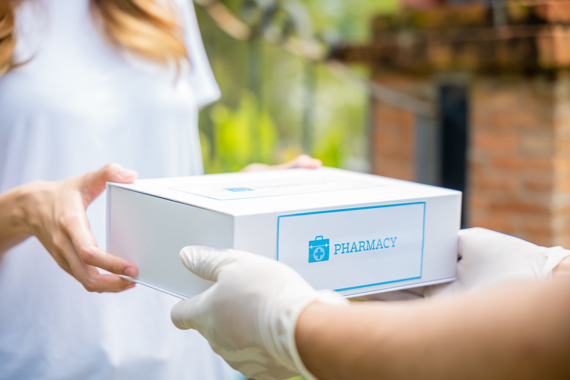 Sick Asian young woman receive medicine first aid pharmacy box from hospital delivery service